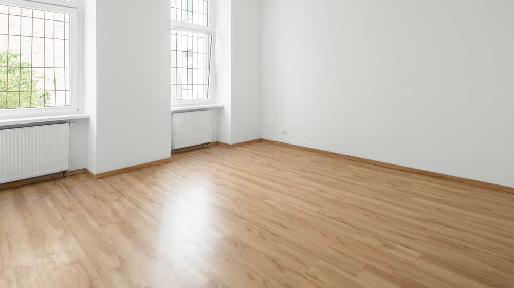 A room with wood flooring.
